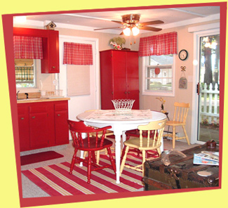 This cozy cottage was in need of an updated d&eacute;cor on a shoestring budget. Painting the old cupboards a cranberry red breathed new life into the kitchen and supplied a wonderful color pallet to work from throughout the cottage.